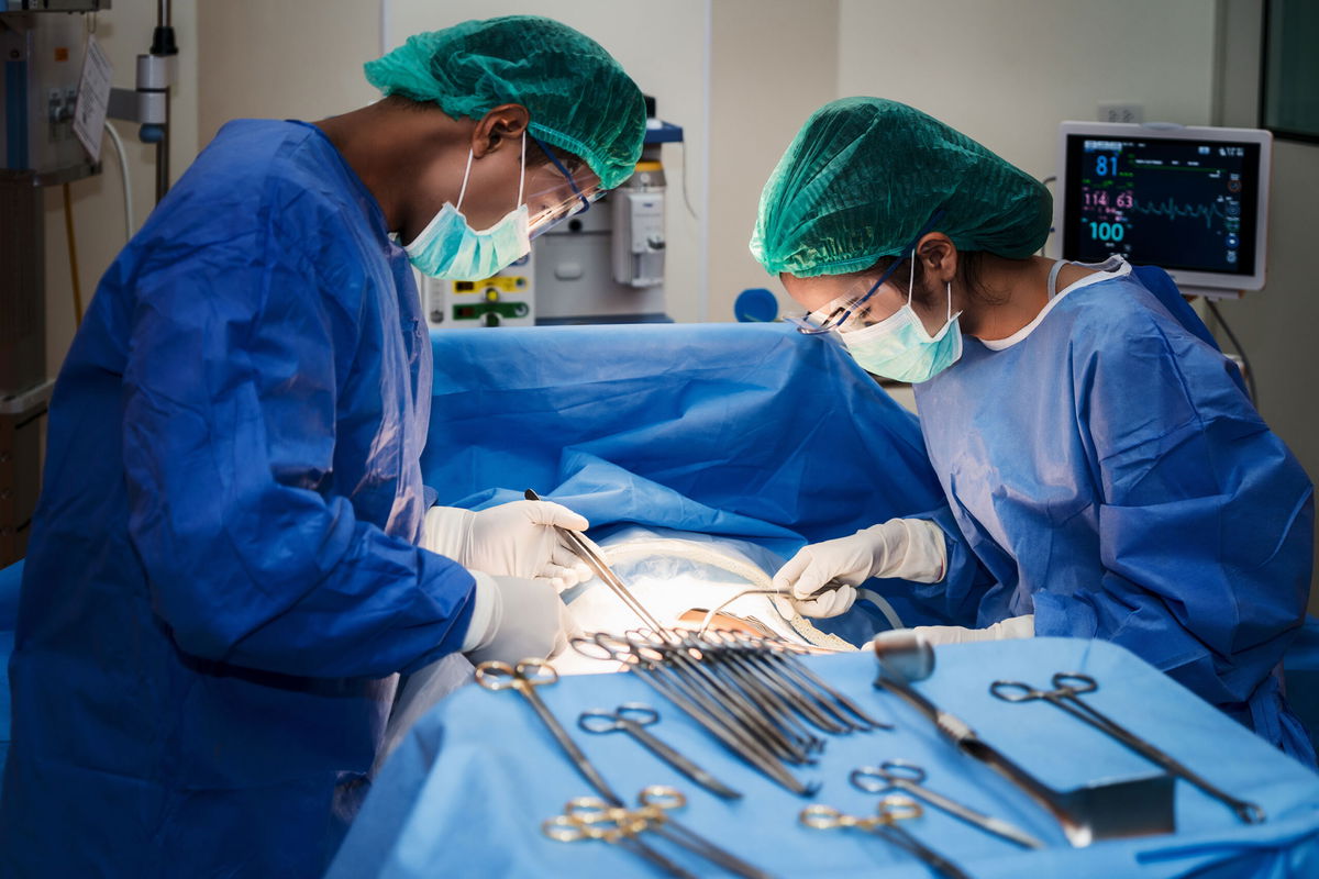 Asian doctor and an assistant in the operating room for surgical venous vascular surgery clinic in hospital.