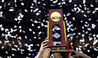 The Kansas Jayhawks celebrate with the trophy after defeating the North Carolina Tar Heels during the 2022 NCAA Men's Basketball Tournament National Championship at Caesars Superdome in 2022.