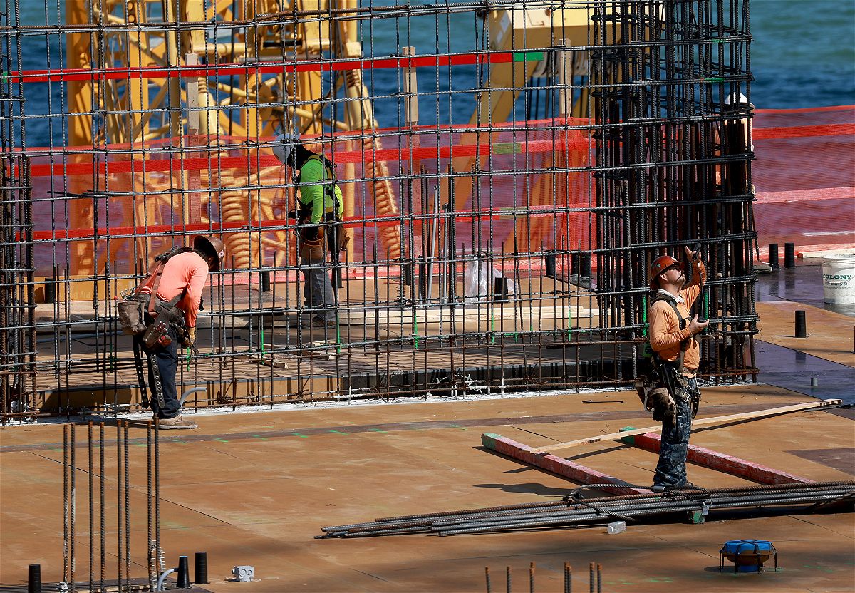 <i>Joe Raedle/Getty Images</i><br/>Construction workers on a job site on March 10