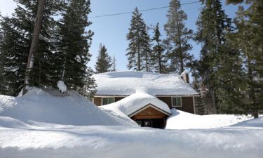 A home is seen buried in snow on March 3 in Twin Bridges