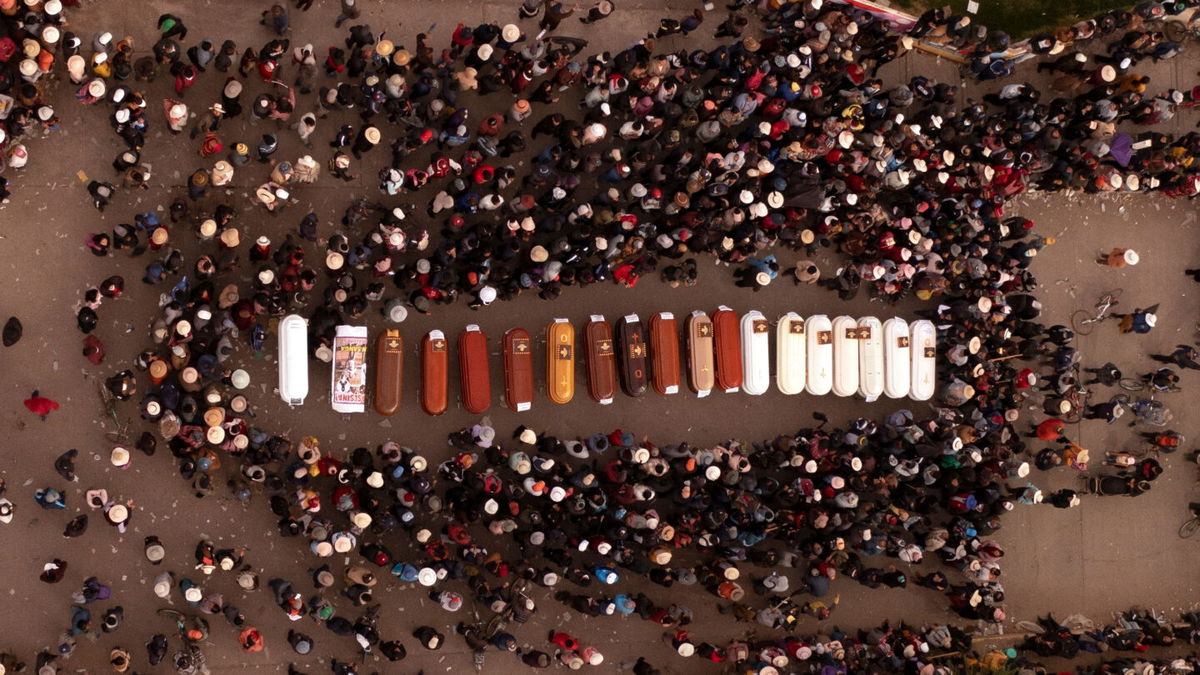 <i>Jose Sotomayor/AP/FILE</i><br/>People surround the coffins of people who died during unrest in Juliaca