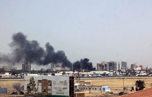 Heavy smoke bellows above buildings in the vicinity of the Khartoum's airport on April 15
