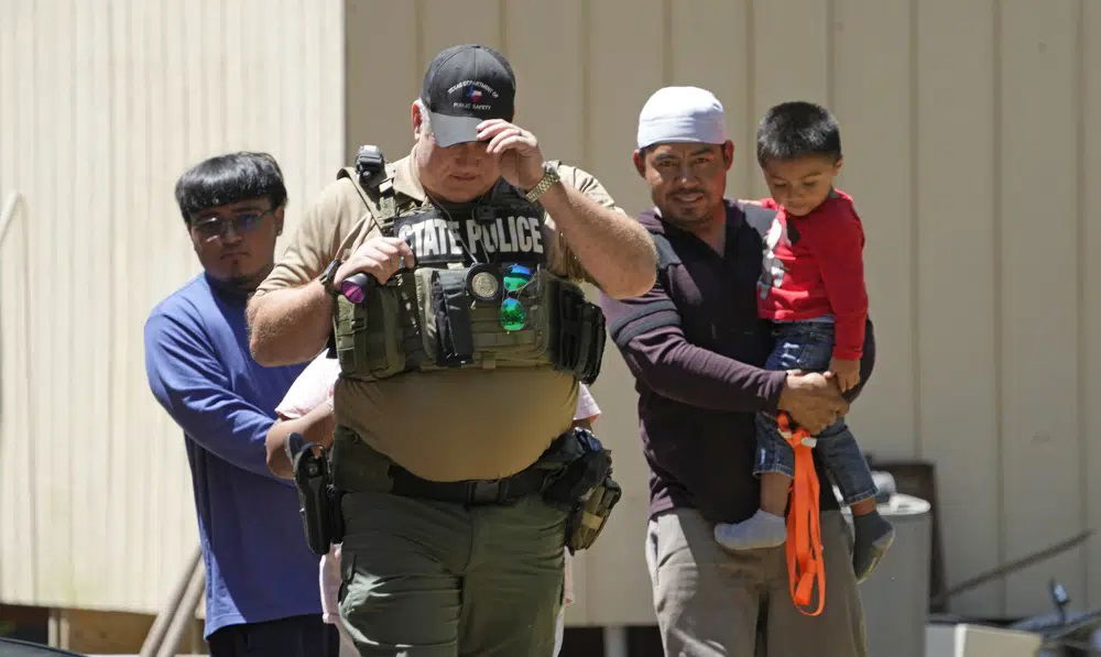 A law enforcement official works Sunday, April 30, 2023, in the neighborhood where a mass shooting occurred Friday night, in Cleveland, Texas. The search for a man who allegedly shot his neighbors after they asked him to stop firing off rounds in his yard stretched into a second day Sunday, with authorities saying the man could be anywhere by now. Francisco Oropesa, 38, fled after the shooting Friday night that left several people dead, including an 8-year-old boy. 