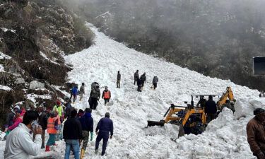 Rescuers comb the site of the avalanche for survivors on Tuesday.