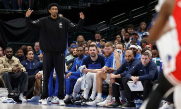 Luka Dončić (center) and the Mavericks bench watch on during the game against the Chicago Bulls.