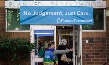 A clinic escort assists a patient at a Planned Parenthood Health Center in Philadelphia in September of 2022.