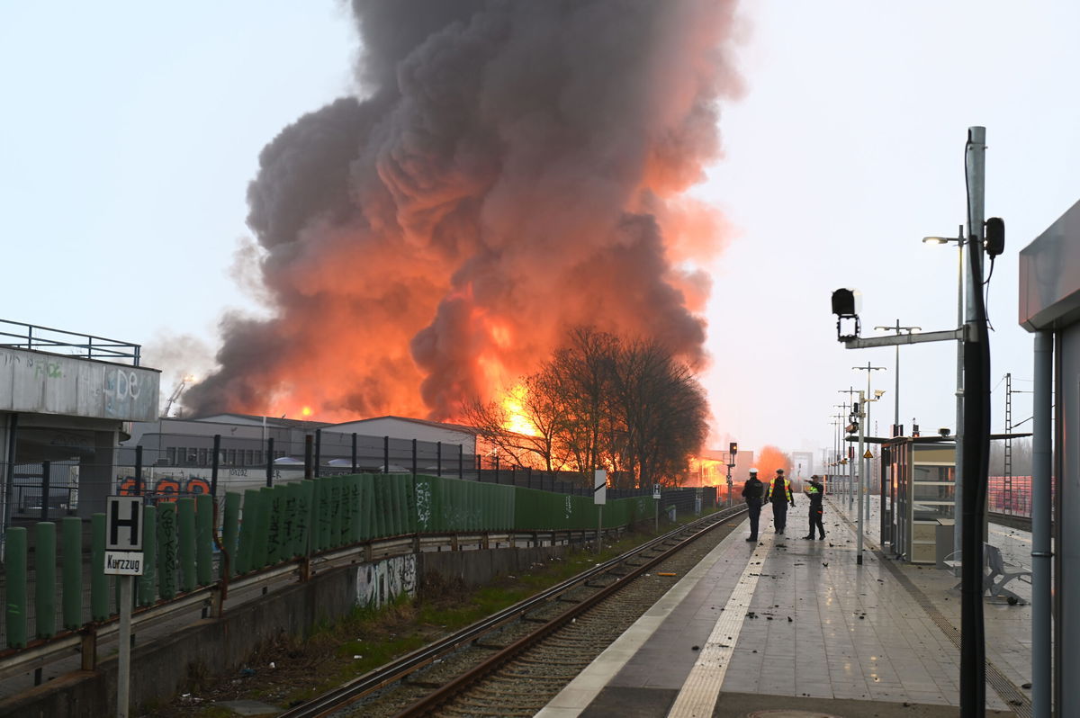 <i>Jonas Walzberg/picture alliance/dpa/Getty Images</i><br/>The fire sent a large cloud of smoke over the city.