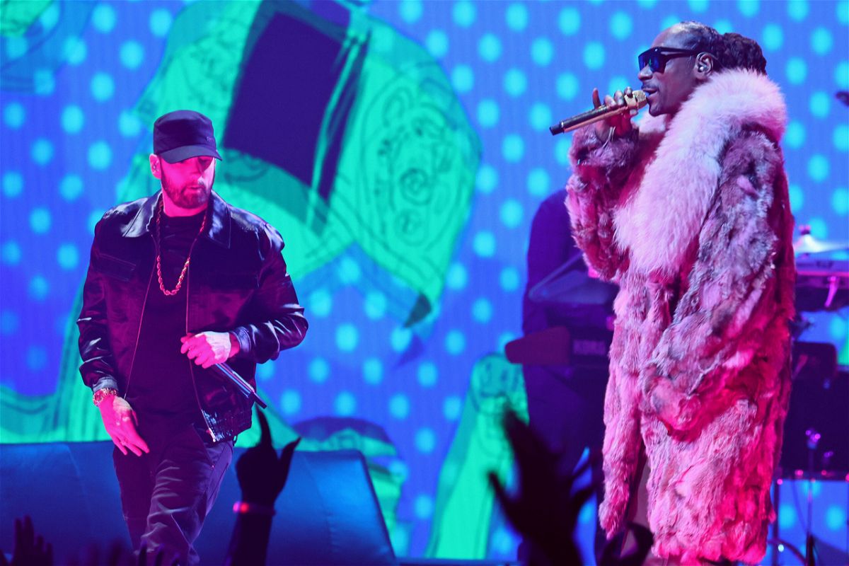 <i>Theo Wargo/Getty Images for MTV/Paramount Global</i><br/>Eminem and Snoop Dogg perform onstage at the 2022 MTV VMAs. The performance included a video of them as BAYC characters.