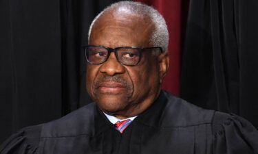 Associate US Supreme Court Justice Clarence Thomas poses for the official photo at the Supreme Court in Washington