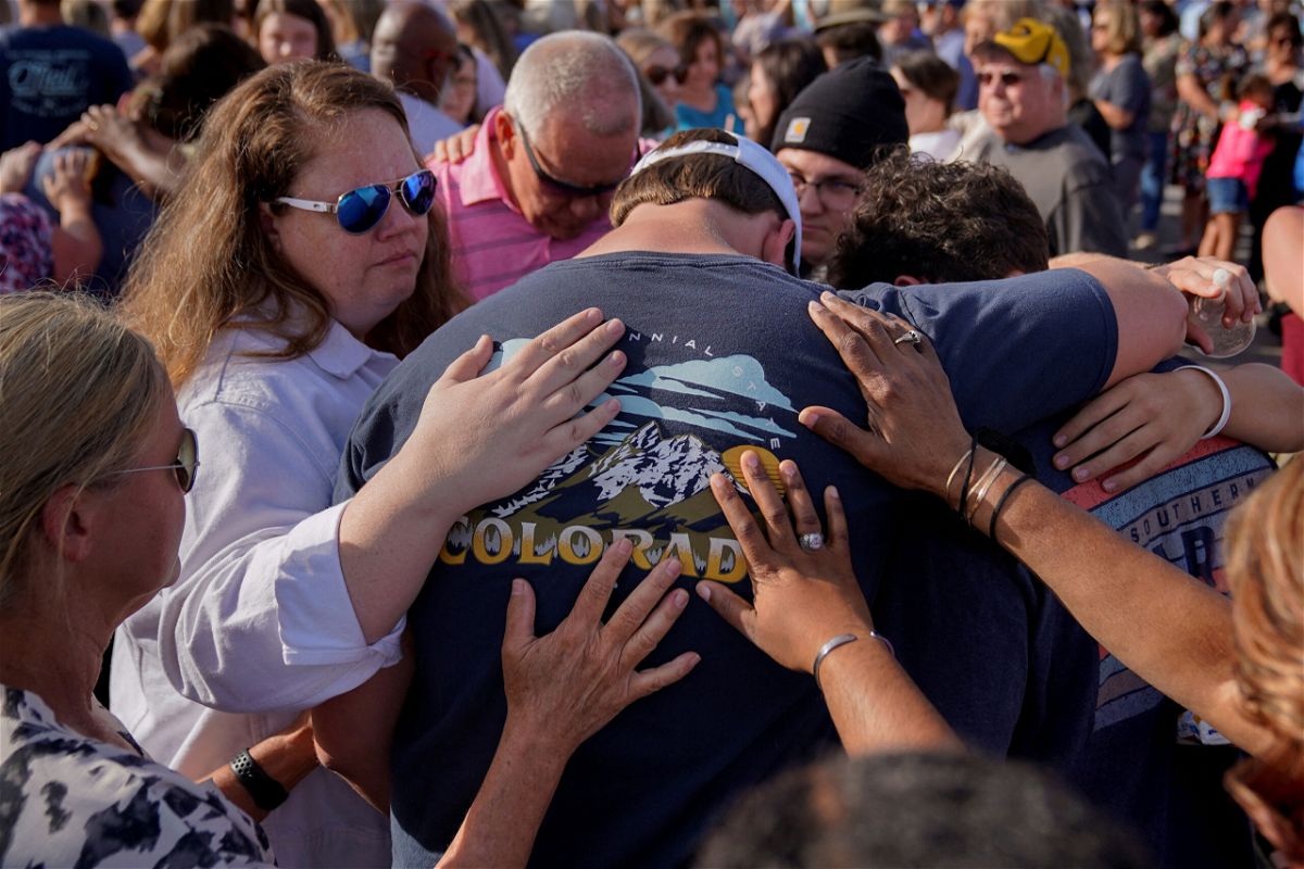 Community members embrace each other during a vigil the day after a shooting during a teenager's birthday party at Mahogany Masterpiece Dance Studio in Dadeville, Alabama, U.S., April 16, 2023. REUTERS/Cheney Orr