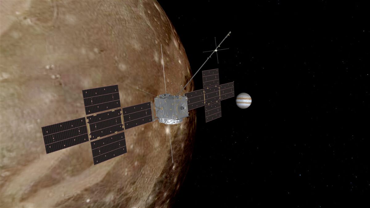 <i>European Space Agency</i><br/>An artist's rendering depict Juice flying by Ganymede with Jupiter in the background.