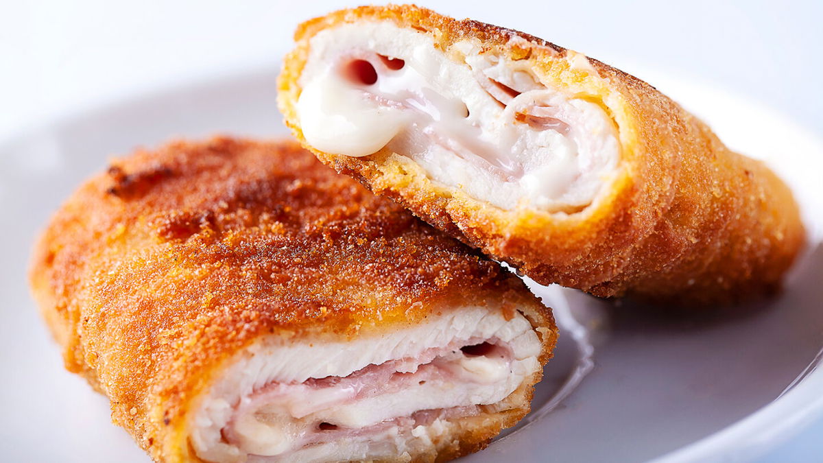 Close-up of chicken cordon bleu on white background