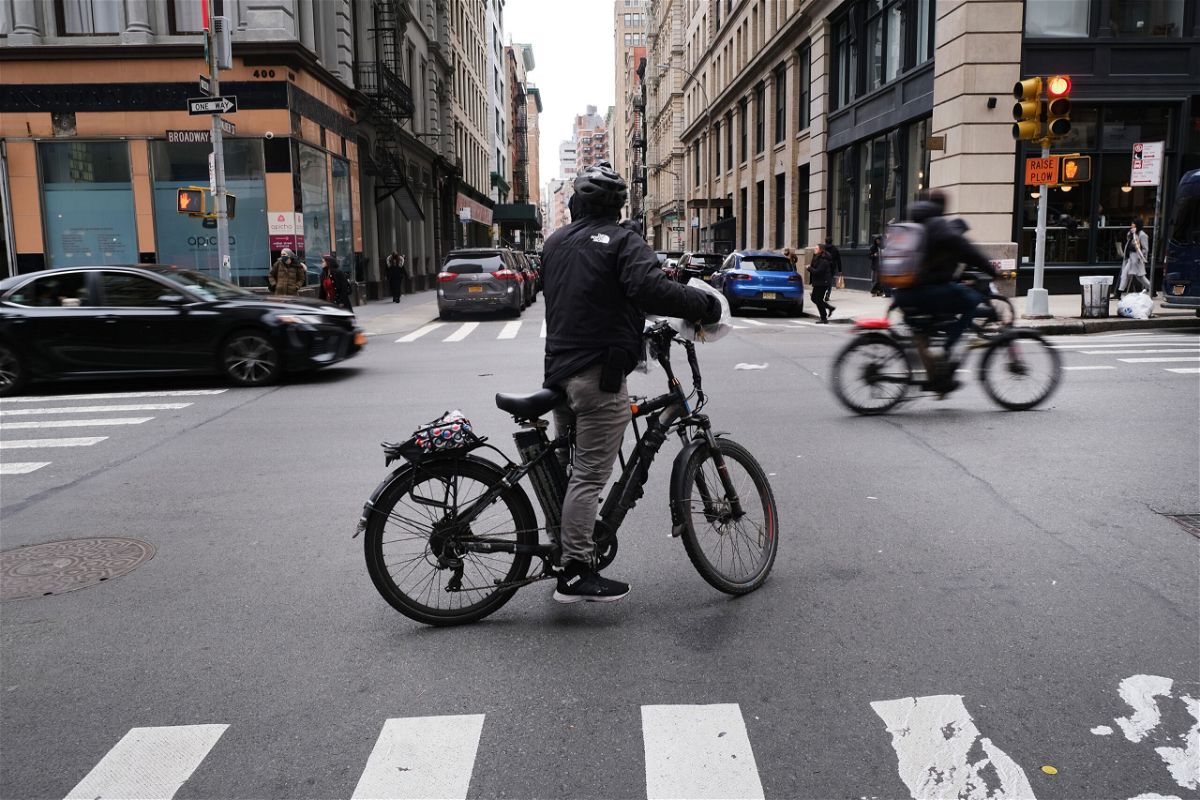 <i>Spencer Platt/Getty Images</i><br/>An electric bicycle moves through the streets of Manhattan in November 2022 in New York City.