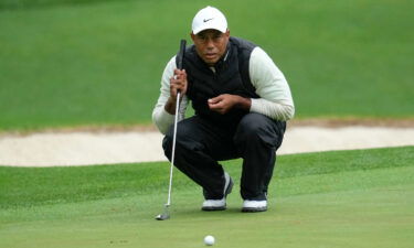 Tiger Woods lines up a putt on the 16th hole during the weather delayed second round of the Masters golf tournament at Augusta National Golf Club on Saturday