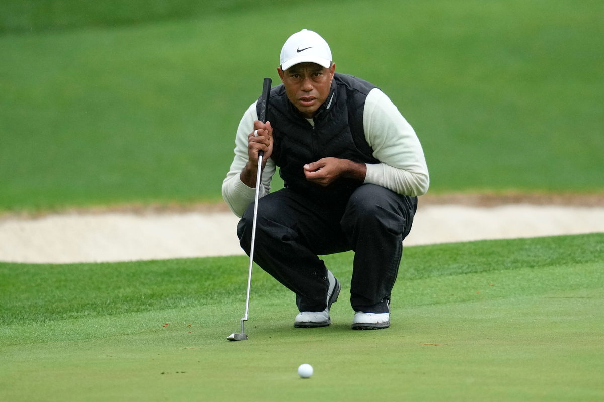 <i>Mark Baker/AP</i><br/>Tiger Woods lines up a putt on the 16th hole during the weather delayed second round of the Masters golf tournament at Augusta National Golf Club on Saturday