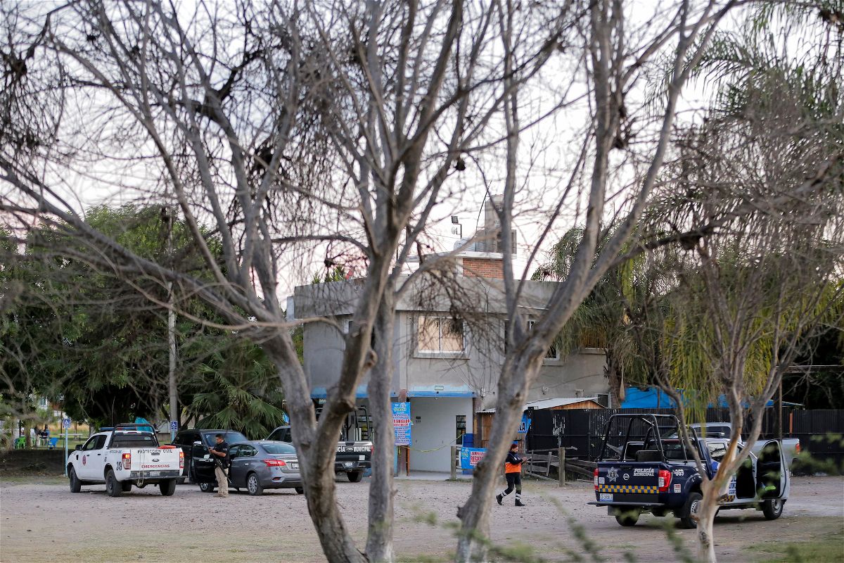 Authorities at the crime scene where gunmen killed several people including a child at a water park in Cortazar