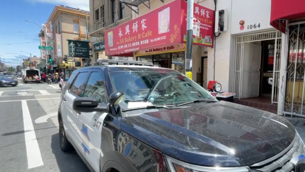 San Francisco Police car parked in front of the AA Bakery and Cafe