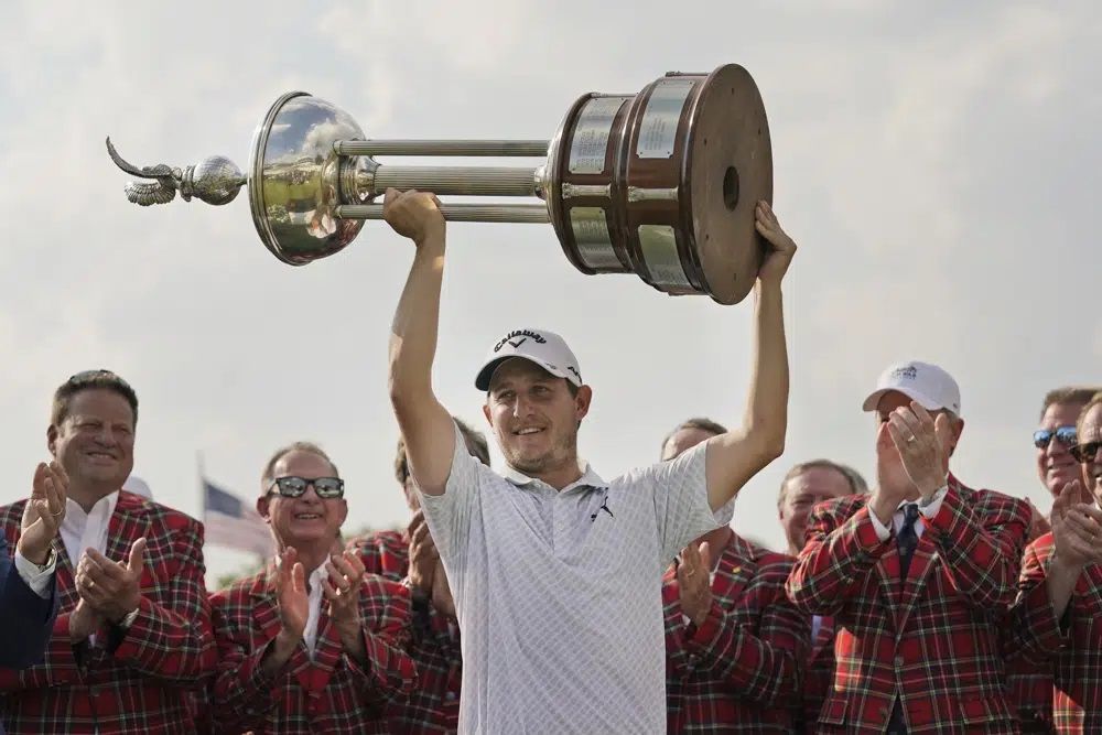Emiliano Grillo, of Argentina, lifts the trophy after winning the Charles Schwab Challenge golf tournament at Colonial Country Club in Fort Worth, Texas, Sunday, May 28, 2023