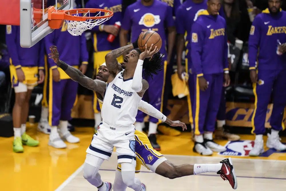 FILE: Memphis Grizzlies' Ja Morant (12) drives to the basket against Los Angeles Lakers' Jarred Vanderbilt during the first half in Game 6 of a first-round NBA basketball playoff series Friday, April 28, 2023, in Los Angeles. 