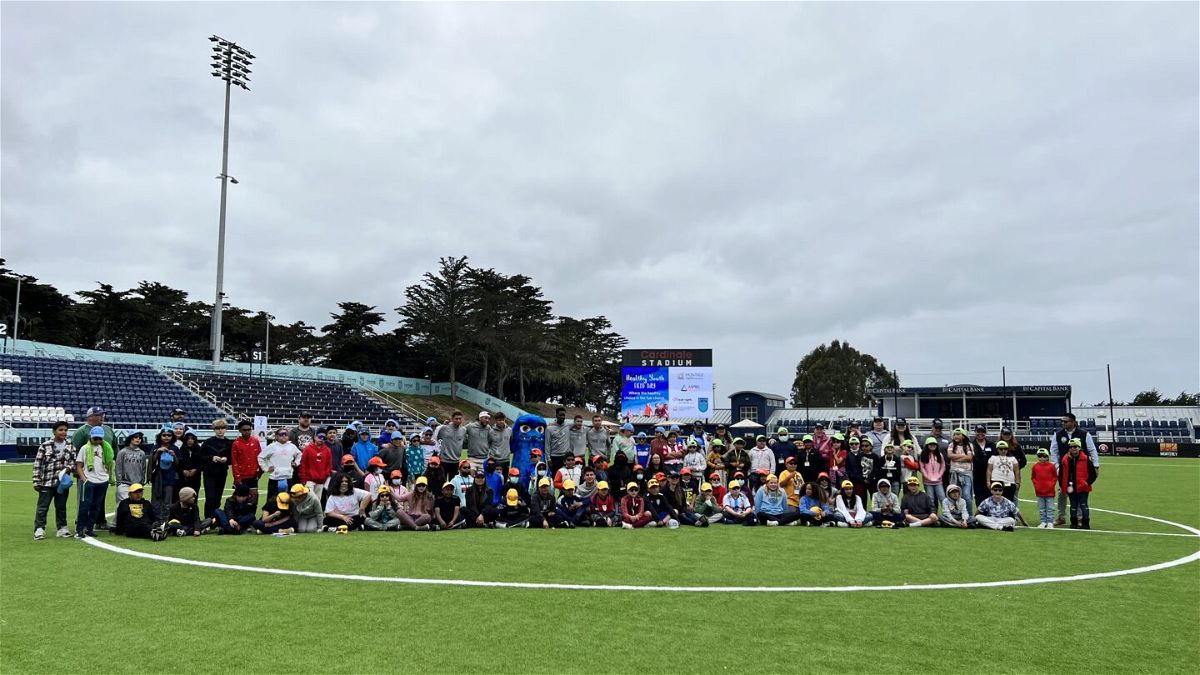 Photo of Monterey Bay F.C. players with Monterey County elementary school students who participated in Field Day. 