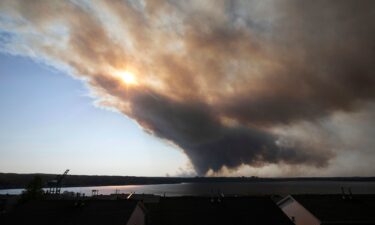 A thick plume of smoke wafts from an out-of-control fire that engulfed multiple homes in Halifax