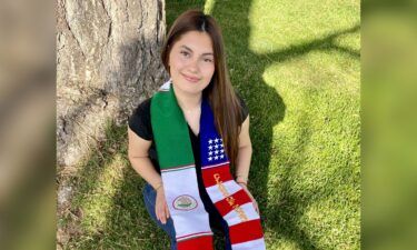 Naomi Peña Villasano poses with a sash of the Mexican and American flags.