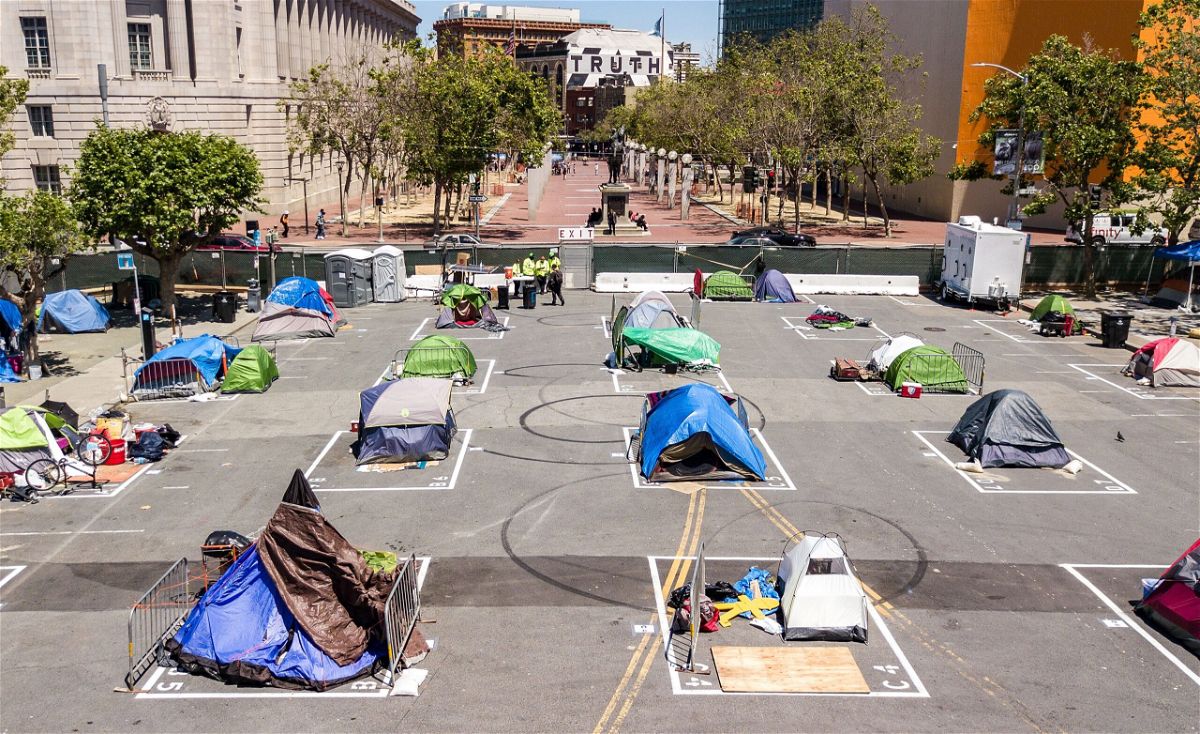 <i>Josh Edelson/AFP via Getty Images</i><br/>Rectangles are painted on the ground to encourage homeless people to keep social distancing at a city-sanctioned homeless encampment across from City Hall in San Francisco in May 2020.