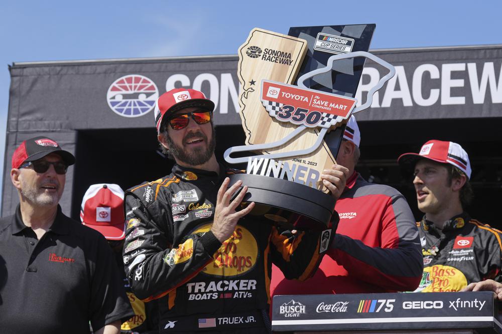 Martin Truex Jr. holds the trophy after winning a NASCAR Cup Series auto race at Sonoma Raceway, Sunday, June 11, 2023, in Sonoma, Calif.