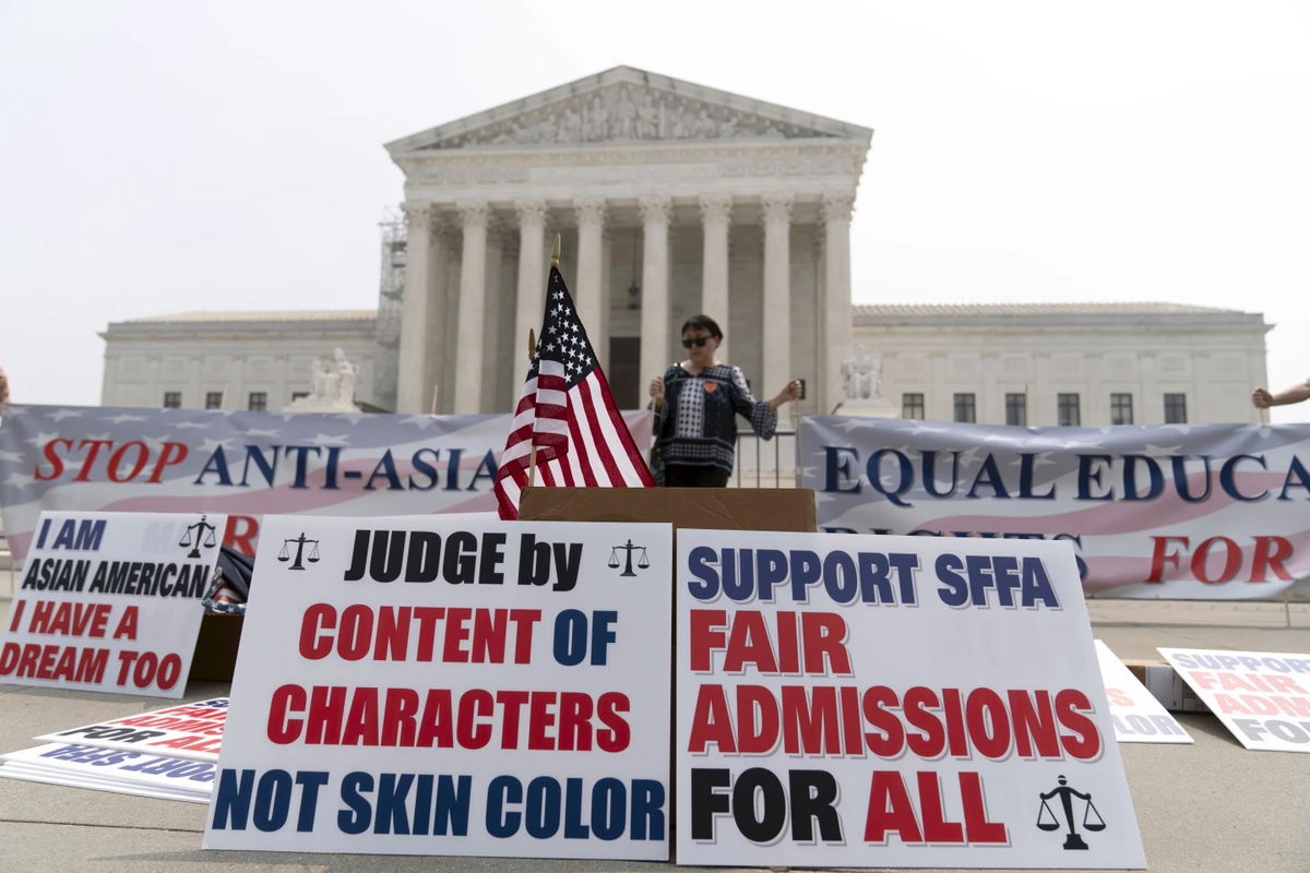 A person protests outside of the Supreme Court in Washington, Thursday June 29, 2023. The Supreme Court on Thursday struck down affirmative action in college admissions, declaring race cannot be a factor and forcing institutions of higher education to look for new ways to achieve diverse student bodies. 