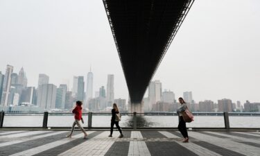 People walk through a Brooklyn Park in New York City on Tuesday morning. Air pollution levels were unhealthy for sensitive groups due to smoke from Canada's wildfires.