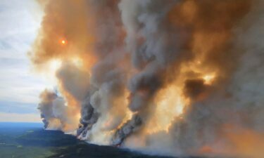 Smoke rises from a wildfire south of Fort Nelson