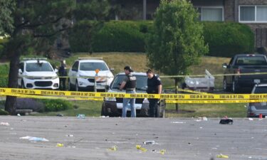 Investigators look over the scene of an overnight mass shooting in Willowbrook