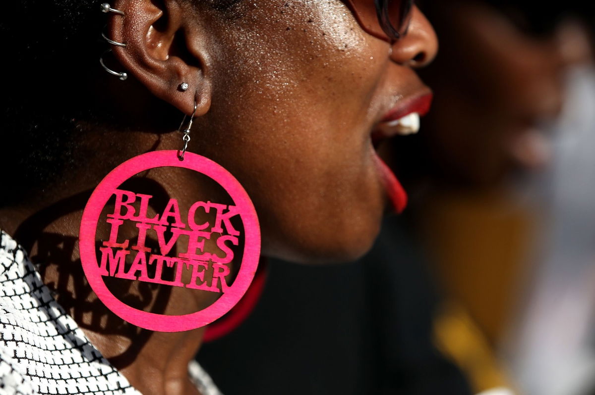 <i>Justin Sullivan/Getty Images</i><br/>A Black Lives Matter protester wears custom earrings during a demonstration outside of office of Sacramento district attorney Anne Schubert on March 28