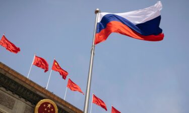 The Russian national flag flies in front of the Great Hall of the People before a welcoming ceremony for Russian Prime Minister Mikhail Mishustin in Beijing