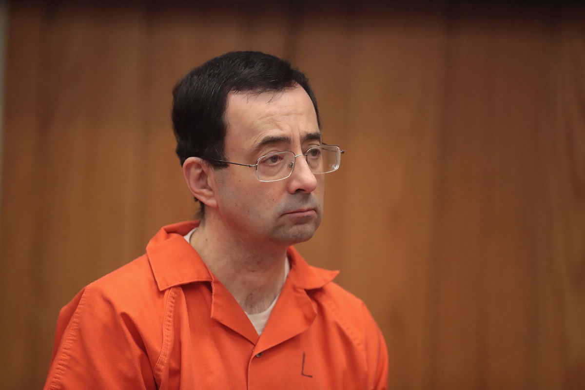 <i>Scott Olson/Getty Images/FILE</i><br/>Larry Nassar stands as he is sentenced for three counts of criminal sexual assault on February 5