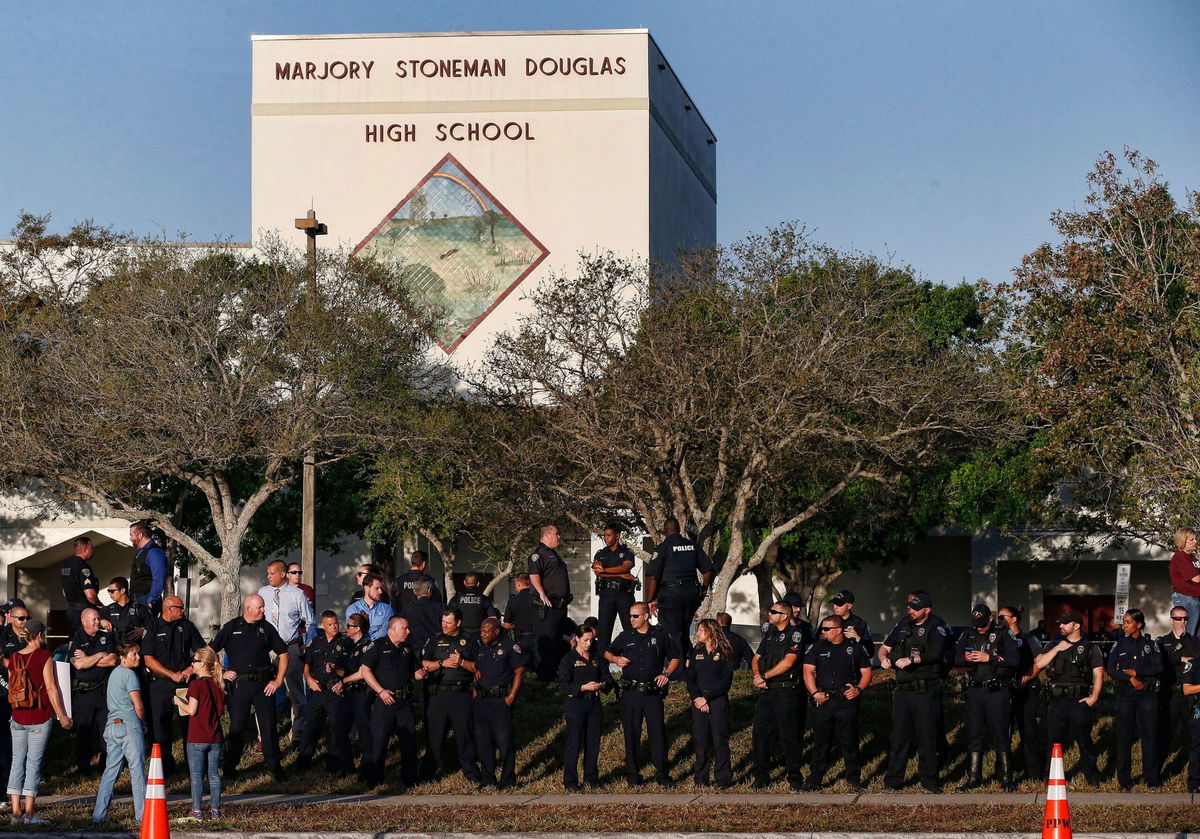 <i>Rhona Wise/AFP/Getty Images</i><br/>Marjory Stoneman Douglas High School students and staff return to school greeted by police and well wishers February 28