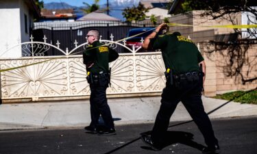 San Bernardino County sheriff's investigators work the scene where three people were found dead in unincorporated San Bernardino County near Montclair