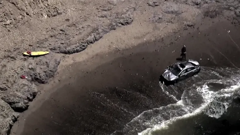 A screenshot from KTVU's SkyFOX footage shows a vehicle in the Pacific Ocean after it drove off of Highway 1 in Santa Cruz County on Friday July 14, 2023.