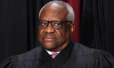 Associate US Supreme Court Justice Clarence Thomas poses for the official photo at the Supreme Court in Washington