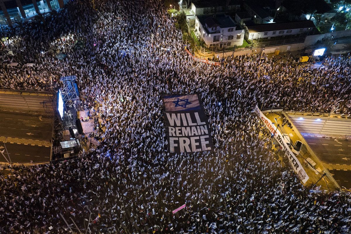<i>Oded Balilty/AP</i><br/>Tens of thousands of Israelis protest against plans by Prime Minister Benjamin Netanyahu's government to overhaul the judicial system in Tel Aviv