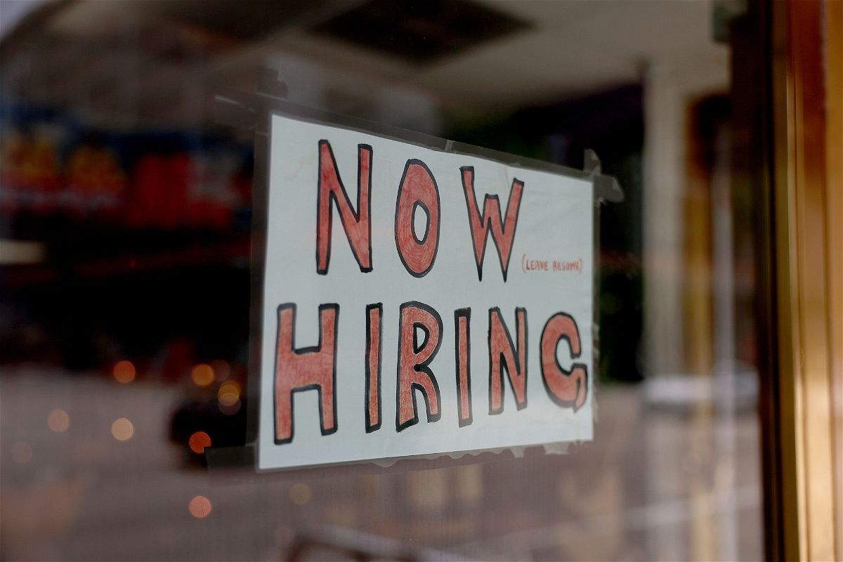 <i>Joe Raedle/Getty Images</i><br/>A 'Now Hiring' sign posted on the window of a business looking to hire workers on May 05
