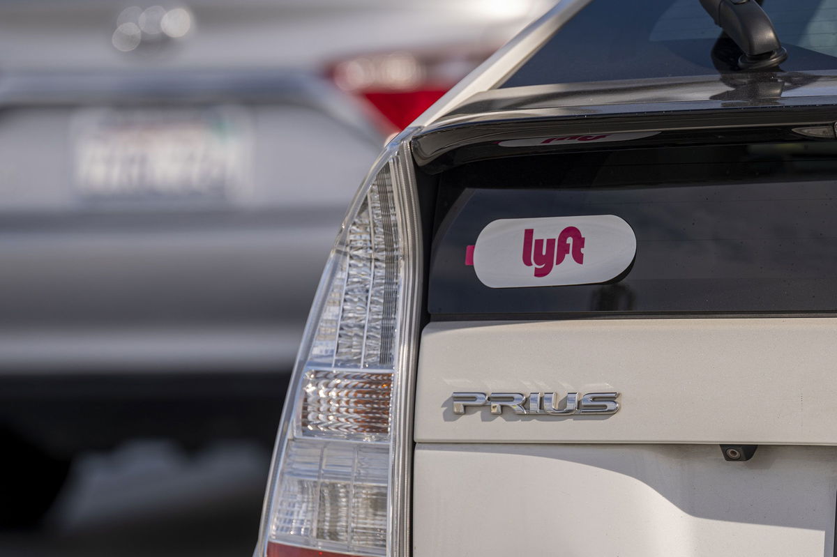 <i>David Paul Morris/Bloomberg/Getty Images</i><br/>Lyft signage is pictured on a vehicle as it exits the ride-sharing pickup at San Francisco International Airport on February 3