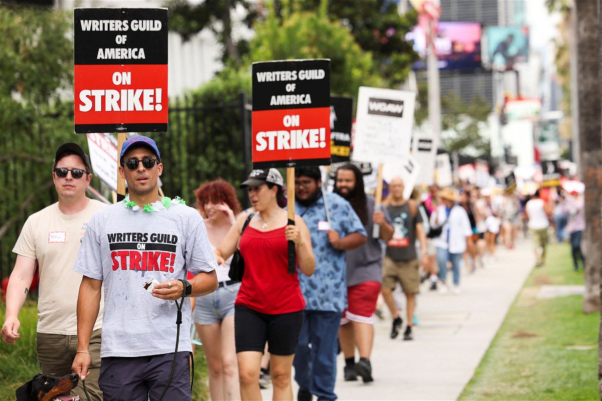 <i>Mario Anzuoni/Reuters</i><br/>SAG-AFTRA actors and Writers Guild of America (WGA) writers walk the picket line during their ongoing strike