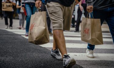 Shoppers carry retail bags along the Magnificent Mile shopping district in Chicago on Aug. 15. US retail sales rose in July by more than forecast
