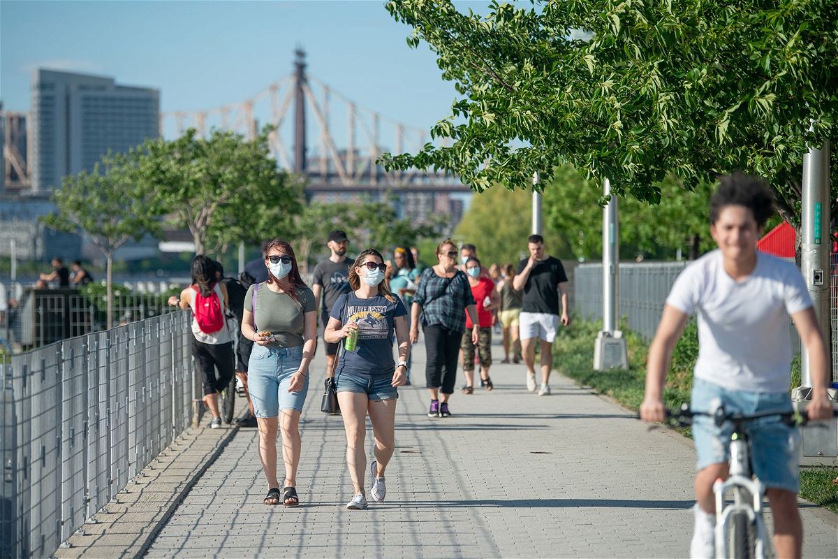 <i>Alexi Rosenfeld/Getty Images/File</i><br/>People walk in Gantry Plaza State Park in New York City.