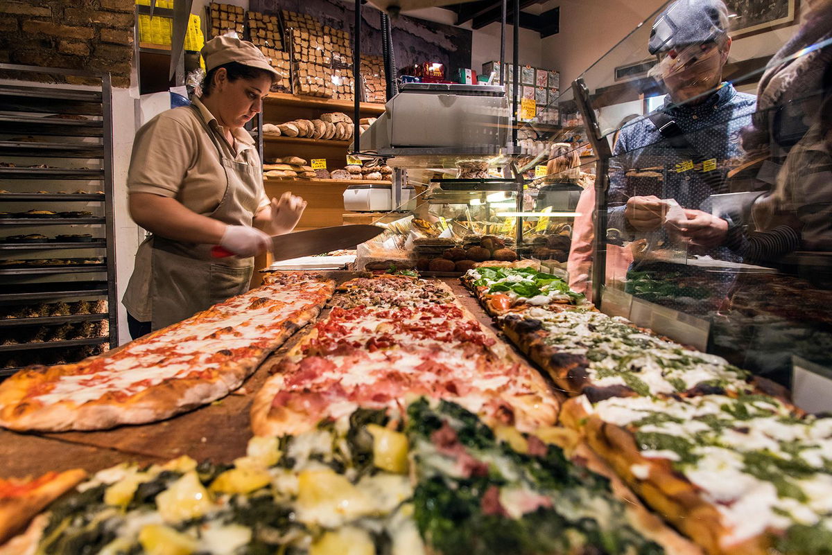 <i>Stefano Politi Markovina/Alamy Stock Photo</i><br/>Different varieties of pizza served al taglio in a bakery of Rome's Trastevere neighborhood.