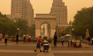Pedestrians are pictured here at Washington Square Park as smoke from Canada wildfires blankets New York on June 7.