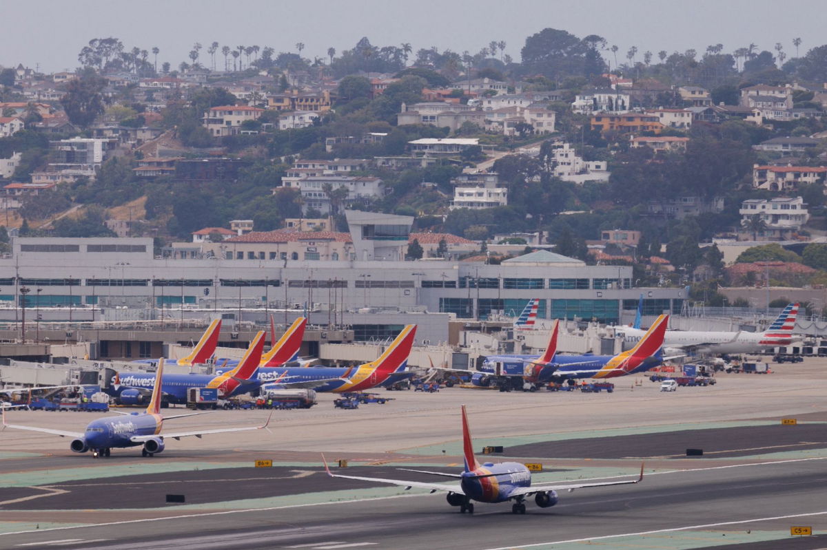 <i>Mike Blake/Reuters/FILE</i><br/>Southwest Airlines planes are shown at San Diego International Airport in a May 2023 file photo. A pilot who nearly landed a private jet on top of a commercial jetliner apparently noticed the other plane still on the runway