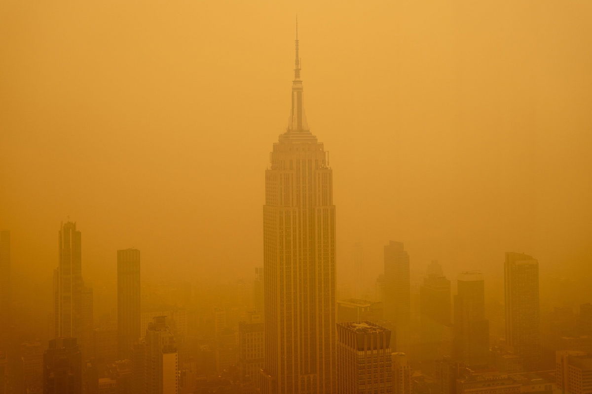 <i>David Dee Delgado/Getty Images</i><br/>Smoky haze from wildfires in Canada diminishes the visibility of the Empire State Building on June 7 in New York City. Wildfires in Canada that caused smoke to blanket parts of the United States in recent months were linked to a significant rise in emergency hospital visits related to asthma.