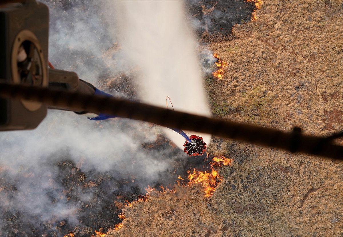 <i>Patrick T. Fallon/AFP/Getty Images</i><br/>An aerial image taken on August 10 shows a person walking down Front Street past destroyed buildings burned to the ground in Lahaina in the aftermath of wildfires in western Maui